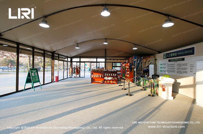 Small exhibition tent interior with service counter and product display booths